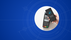 Hand holding a smartphone that shows 'Payment successful' beside a handheld card reader on a white circular panel against a blue technical background.
